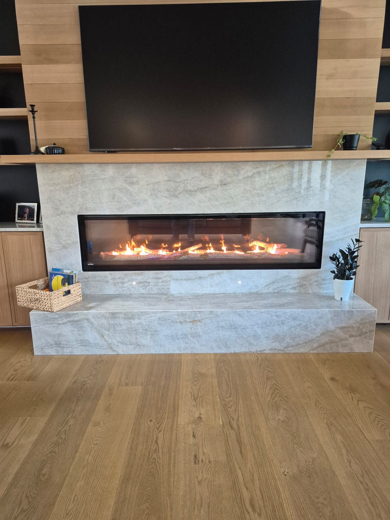 Linear gas fireplace with quartzite surround installed by Central Air Solutions